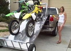 Women displaying her two motor sports