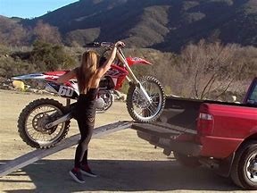 Woman loading her big bike to the car