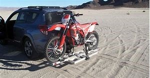 Motor bike with a car in the middle of desert